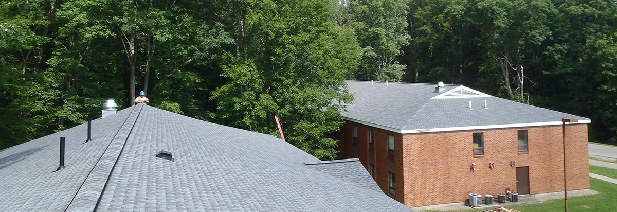 Aerial view of a completed architectural-shingle re-roof on a two-building brick complex